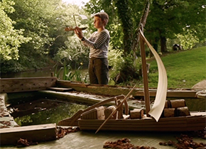 Enfant avec sa maquette d'un bateau en carton le long de la Loire